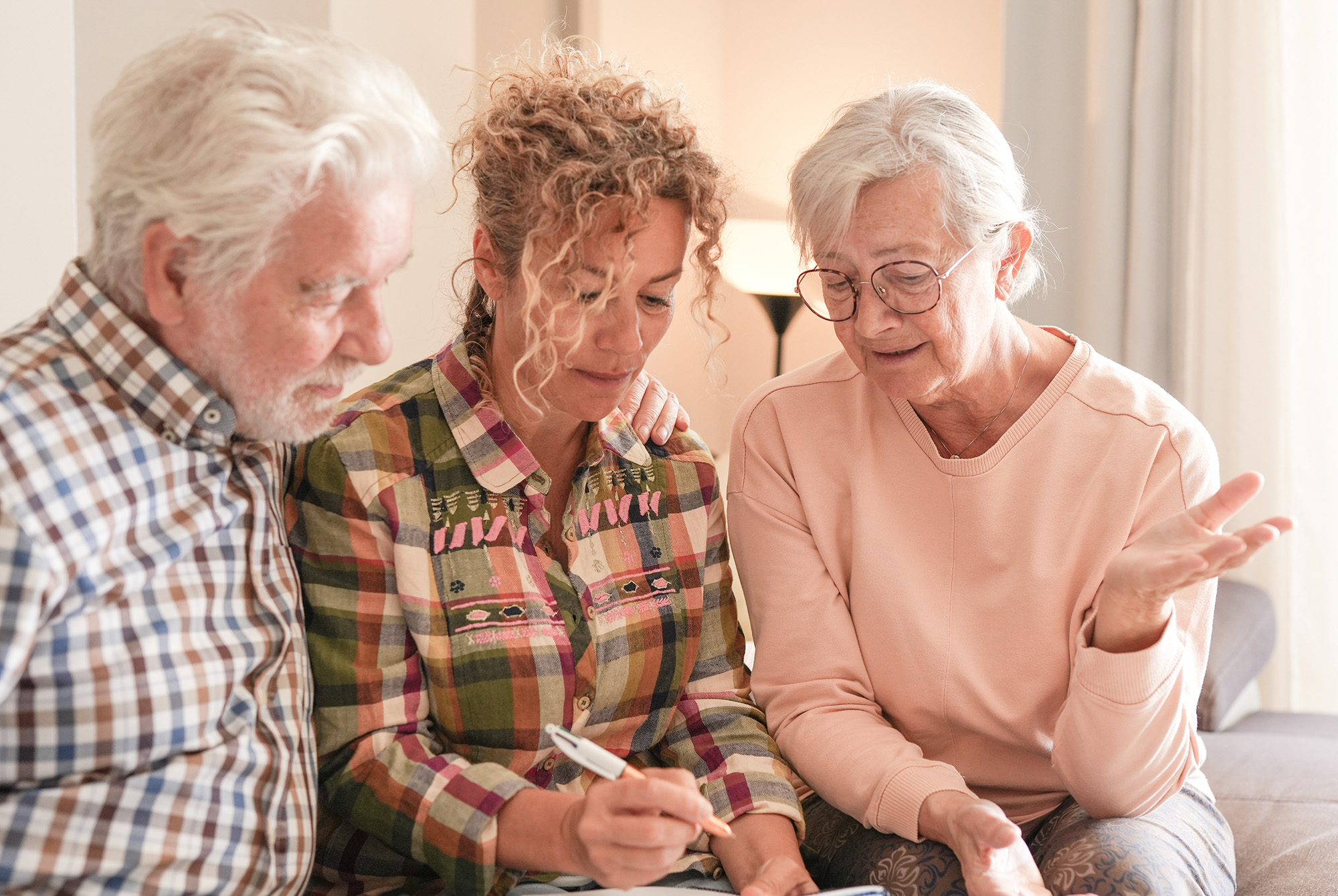 Smiling Senior couple and Caregiver Sharing a Moment sitting together