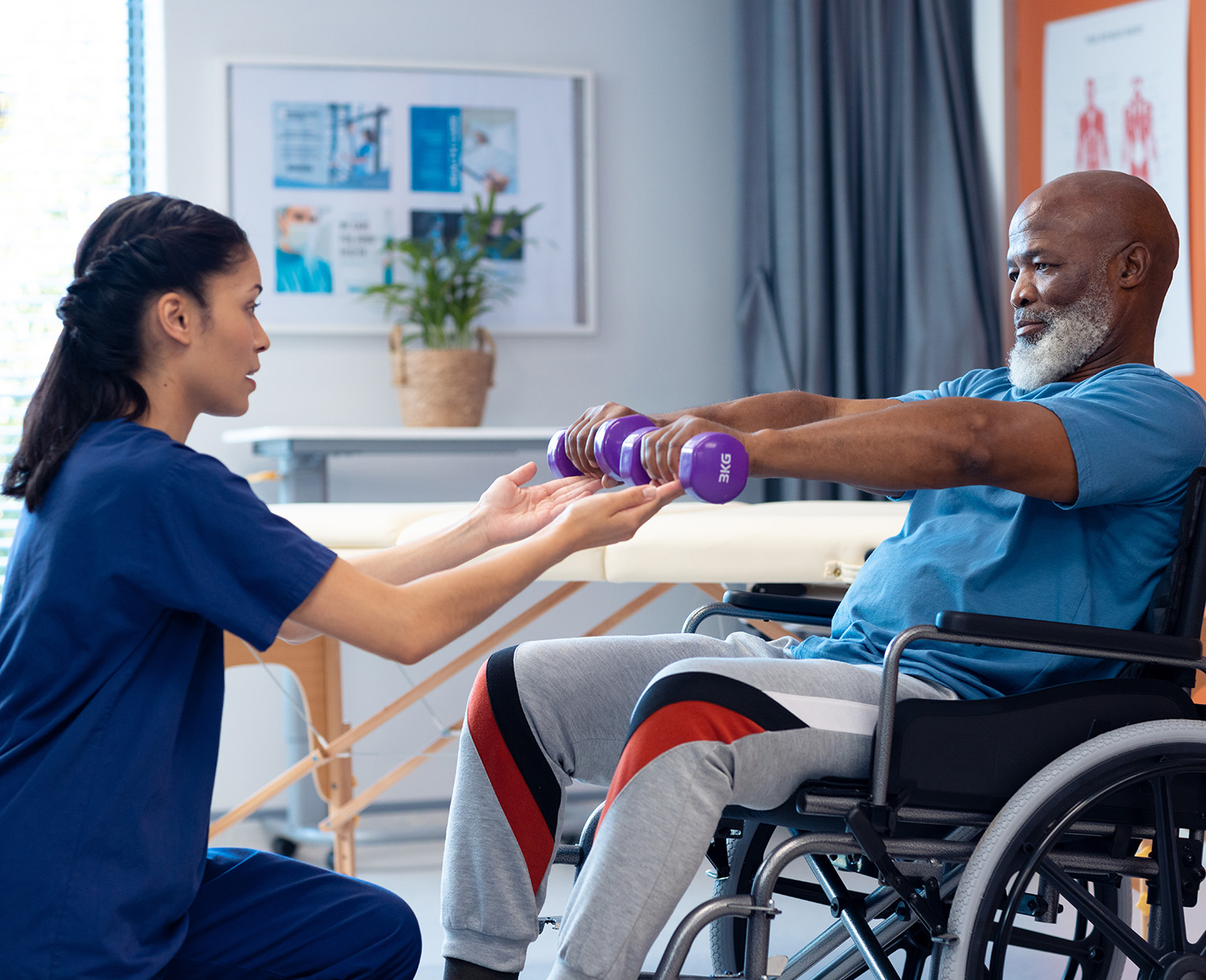 Caregiver helping a patient perform physical therapy exercises
